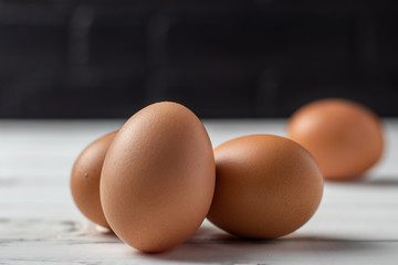 Fresh farm brown eggs over a rustic wood table