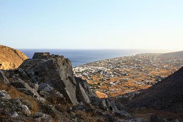 Fototapeta na wymiar View of the village of Perissa on the island of Santorini extending from the trail leading to the peak of Profitis Ilias