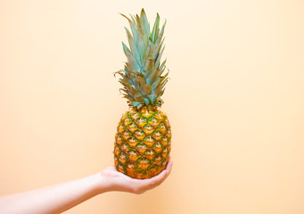 Female hand holds pineapple. Illustration of a healthy diet. The concept of proper nutrition. Fitness and healthy lifestyle.