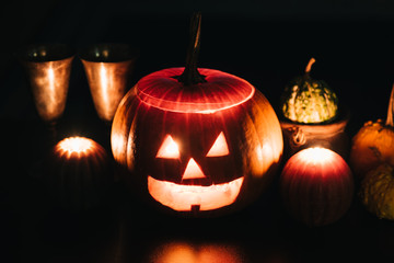 Halloween table decoration with Jack O' Lantern, pumpkins and candles