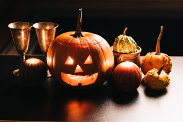 Halloween table decoration with Jack O' Lantern, pumpkins and candles