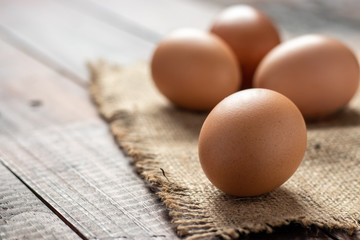 Fresh farm brown eggs over a rustic wood table