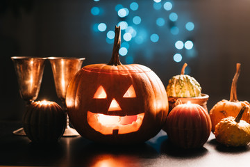 Halloween table decoration with Jack O' Lantern, pumpkins and candles