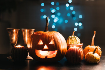 Halloween table decoration with Jack O' Lantern, pumpkins and candles