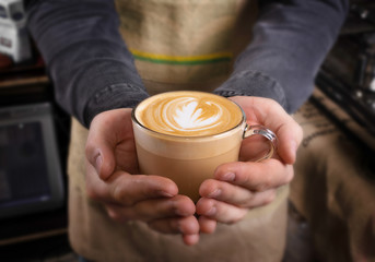 Fototapeta na wymiar Barista makes latte coffee with milk in cafe closeup