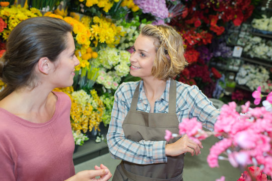 beautiful young female customer smiling with florist