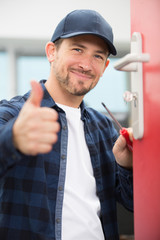 young man worker showing thumb up