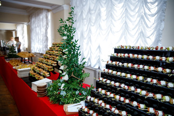 A varied buffet on a long red table.