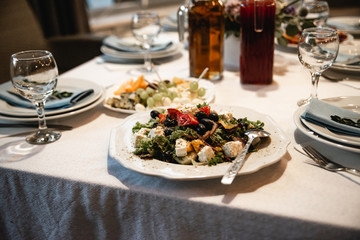 Served table with snacks and empty glasses. Delicious dishes at the wedding ceremony close up. Restourant's table prepared for celebrating event. Party concept