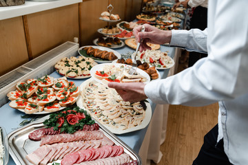 Served table with snacks and empty glasses. Delicious dishes at the wedding ceremony close up. Restourant's table prepared for celebrating event. Party concept
