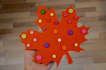 Decorated handmade maple leaf with buttons