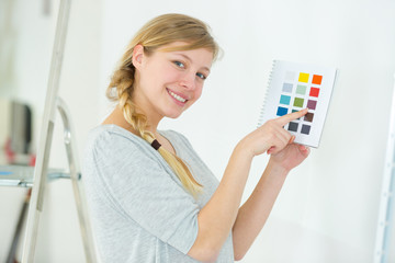 successful designer pointing at whiteboard with samples