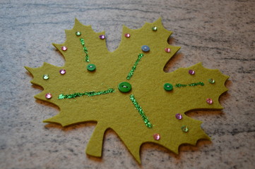 Decorated green handmade maple leaf