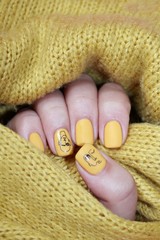 Stylish trendy female manicure. Neon yellow nails on yellow  background. Nail polish. Art manicure. Modern style.