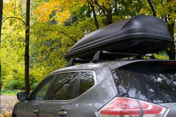 Car in the autumn forest. Travel concept.