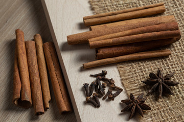 cinnamon sticks and star anise on wooden background