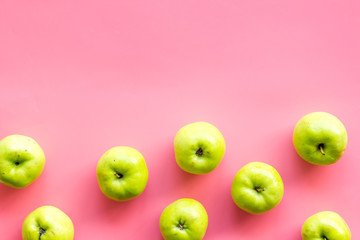 Green apples pattern on pink background top view frame copy space