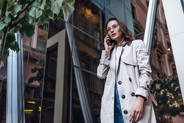 Businesswoman on cellphone running while talking on smart phone. Happy smiling mixed race Asian / Caucasian business woman busy. 