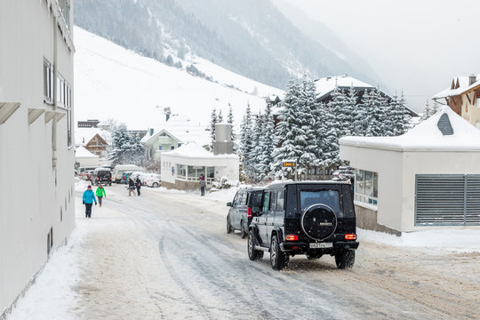 Ischgl, Austria - January 06th, 2018: Black Mercedes-Benz G-class SUV car with russian license plates driving along center of alpine austrian luxury Ischgl resort at Christmas holidays time