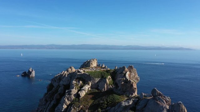 Man standing on a cliff Cap Medes Porquerolles aerial shot summer Hyeres island
