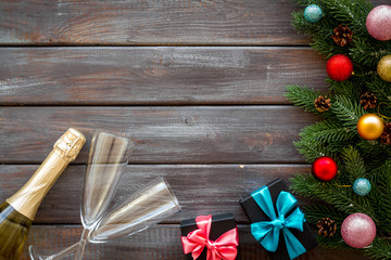Champagne for New Year's Eve on dark wooden background top view frame copy space