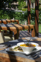 Roasted pumpkin cream soup served with bread on the restaurant table. Exquisite dish. Creative restaurant meal. Fine dining concept.	