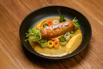 Chicken katsu on mango curry. Exquisite dish. Creative restaurant meal concept.	