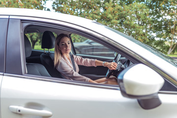 Fashionable stylish girl parking in city, in car, beautiful business woman, woman summer and...