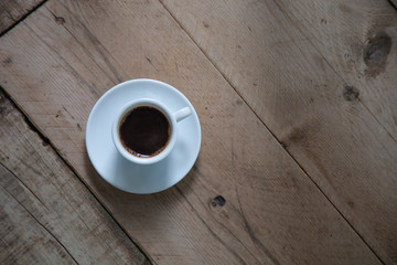 Black Coffee cup on horizontal wooden panels Floor background top view 
