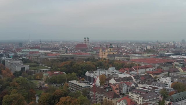 Pan shot with a drone over Munichs English Garden in the colorful autumn, wonderful fall scenery.