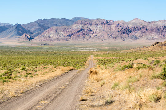 Road heading off through the desert landscape by Pyramid Lake Nevada - Powered by Adobe