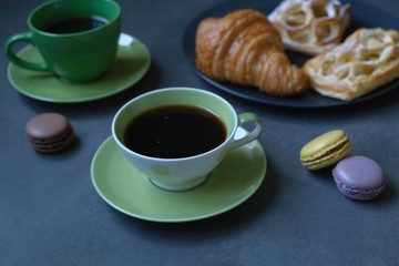Breakfast with coffee, croissant and apple pie. Coffee composition on a dark background 