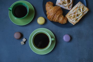 Breakfast with coffee, croissant and apple pie. Coffee composition on a dark background 