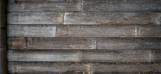 Cool dark brown reclaimed wood bamboo surface. Wooden planks on a wall or floor with grain and texture. Neutral stained vintage wood background.