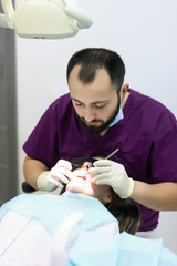 Obraz na płótnie Canvas dentist doctor examines a woman patient medicine checkup