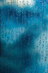 rain drops on window blue background