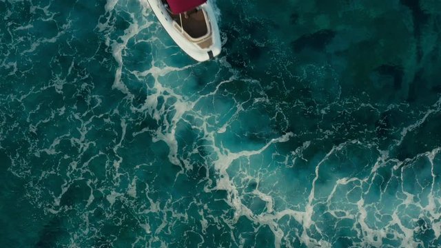 Close up shot of a speed boat with a red roof top making foam and white water.  Top travel destination. 4K.