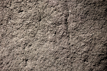 Scabrous gray natural stone or rock texture background