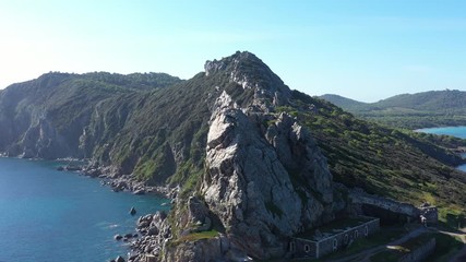 Mediterranean sea Porquerolles batterie des Mèdes aerial close flight over the edge of mountains France