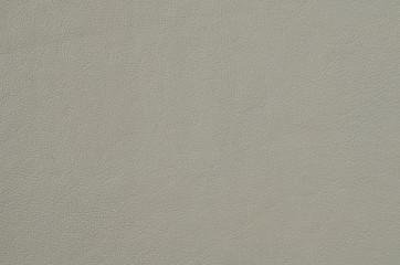 Grey soft leather for the background. Natural leather texture Space for text on the gray background of the skin close up. Artificial leather from polyester.