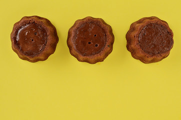 Homemade brownie brownies on yellow background. Delicious chocolate brownie cakes. Close up. Space for text.
