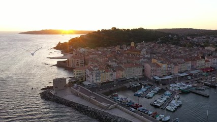 Beautiful sunrise over Saint-Tropez harbor during Voiles de Saint-Tropez regatta full of sailboats