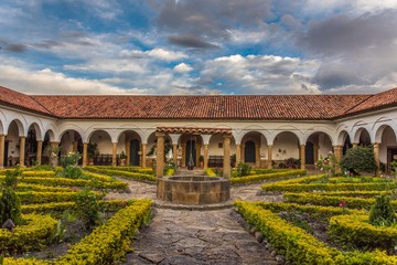 Fototapeta premium Colonial garden with a well in an old monastery