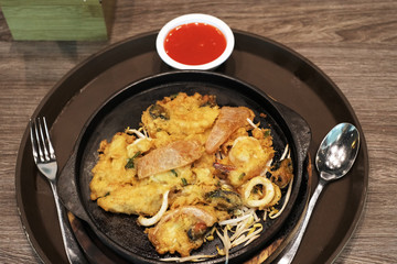 Fried seafood on a hot iron plate