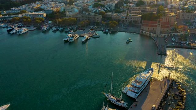 Aerial birds eye view drone video of Rhodes city island, Dodecanese, Greece. Panorama with Mandraki port, lagoon and clear blue water. Famous tourist destination in South Europe.