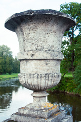 Fototapeta na wymiar old antique vase outside in green park, landscape view