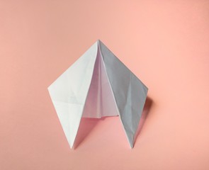 Paper spaceship on pink background. funny concept