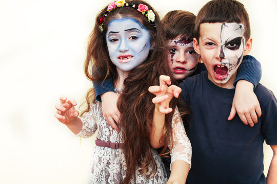 zombie apocalypse kids concept. Birthday party celebration facepaint on children dead bride, scar face, skeleton together having fun, halloween people