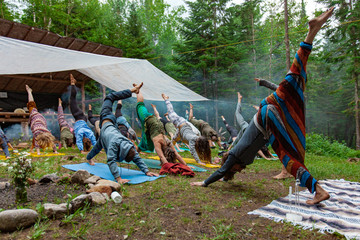 Diverse people enjoy spiritual gathering A colorful mix of intergenerational people are seen practicing traditional and mindful postures during a weekend celebrating native and shamanic cultures.