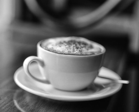 Black and white image of cup of cappuccino